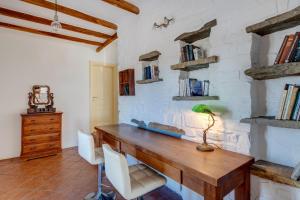 a wooden desk in a room with a brick wall at Villa Danae by the sea in Pounda