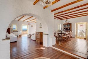 a living room with a table and a dining room at Villa Danae by the sea in Pounda