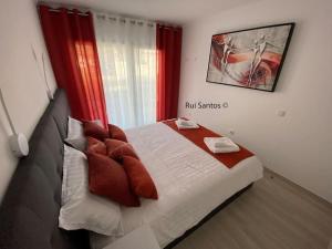 1 dormitorio con 1 cama grande y cortinas rojas en Manta Villa 2, en Manta Rota