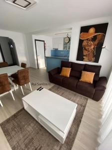 a living room with a couch and a table at Manta Villa 2 in Manta Rota