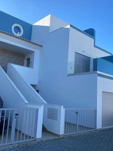 a white building with a staircase in front of it at Manta Villa 2 in Manta Rota
