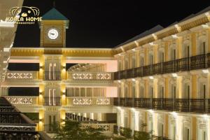 a building with a clock tower on top of it at Riviera Hotel by Owner in Melaka