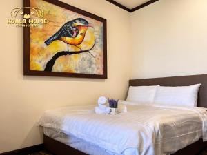 a bedroom with a bed with a painting on the wall at Riviera Hotel by Owner in Melaka +24 photos