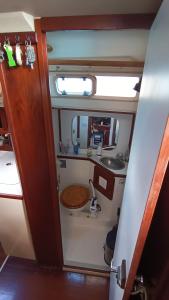 a small bathroom with a sink and a toilet at Sailboat Anemoi Sailing - Private Charter in San Blas in Mamartupo