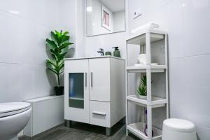 a bathroom with a toilet and a white cabinet at Bioparco Apartment in Valencia