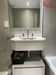lavabo con espejo y cesta debajo en Rent Muñiz en Buenos Aires