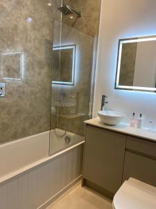 a bathroom with a glass shower and a sink at Rural Retreat in Devon in Plymouth