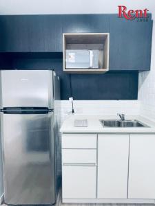 a kitchen with a stainless steel refrigerator and a sink at Rent Muñiz in Buenos Aires
