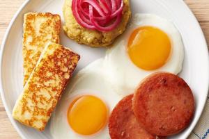 a plate of breakfast food with eggs and toast at The Short STOP free Breakfast private Apartment in Monte Plata