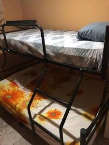 a bunk bed with flowers on the bottom of it at The Short STOP free Breakfast private Apartment in Monte Plata