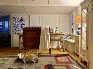 a room with a table and two wine glasses at A unique, off-grid Eco Friendly Beach House. in Wolferton