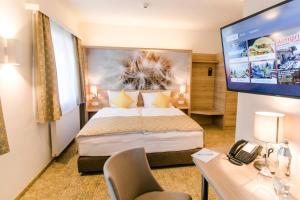TV a/nebo společenská místnost v ubytování R&R Residenzen HOTEL