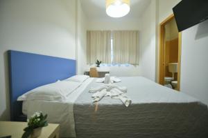 a bedroom with a large white bed with towels on it at Garden Blue in Florence