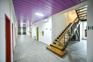 a hallway with a staircase in a building with purple ceilings at Garden Blue in Florence