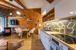 a kitchen with a table and a dining room at Lúčnica apartments Tále in Tale