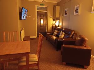 a living room with a couch and a table at Solway Retreat in Gretna