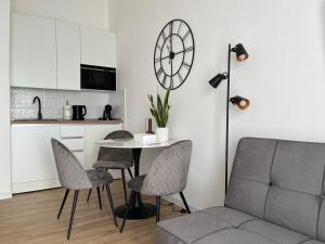 a living room with a table and chairs and a couch at Studio apartman Mia in Županja