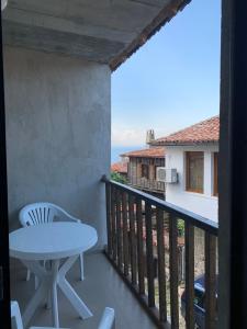 a balcony with a table and a view of the ocean at Sozopol Old Town - Apartment 4 in Sozopol