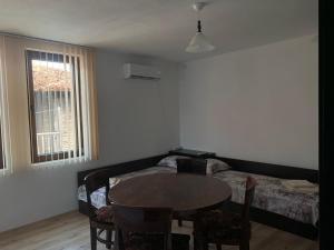 a living room with a table and a bed at Sozopol Old Town - Apartment 4 in Sozopol