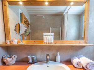 a bathroom with a sink and a mirror at Charmant appart central avec parking à l'Alpe d'Huez - FR-1-645-18 in LʼHuez