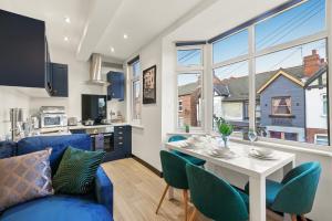 a living room with a blue couch and a table at Beautiful and Boutique Yorkshire Gem - Sleeps 4 in Castleford