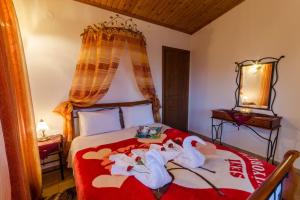 a bedroom with a bed with swans on it at Pelion Maisonette in Tsagarada