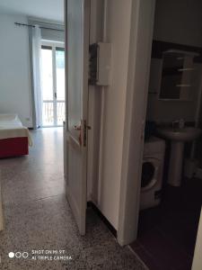 a bathroom with a toilet and a sink and a door at Mare e Monti in Scilla