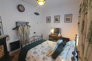 a bedroom with a bed and a clock on the wall at The Railway Sleeper in Cullybackey