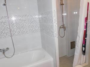 a bathroom with a shower with a tub and a sink at Apartman Braja in Virovitica