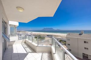 a balcony with a view of the beach at Blouberg Pearl in Cape Town