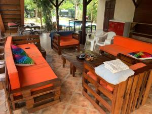 a room with benches and tables and a patio at Pirate and Mermaid Beach House in Puerto Viejo
