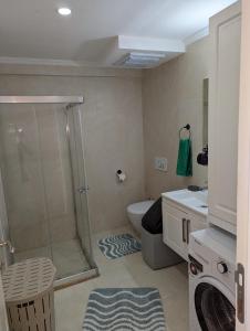 a bathroom with a shower and a toilet and a sink at Vista Panorama Sunshine in Kusadası