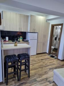 - une cuisine avec un comptoir et quelques tabourets dans l'établissement Mavrov02 Residence, à Mavrovo