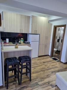 a kitchen with a counter and some stools in it at Mavrov02 Residence in Mavrovo