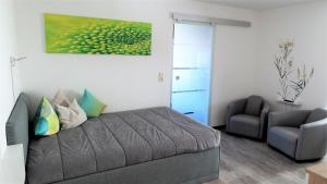 a living room with a couch and a chair at Apartment Enjoy in Rust
