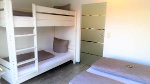 a bedroom with two bunk beds and a bed at Apartment Enjoy in Rust