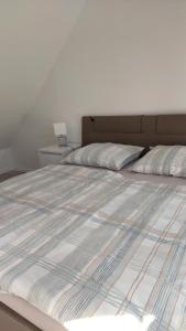Una cama con dos almohadas encima. en Apartma Stela in Terme Čatež, en Čatež ob Savi