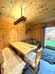 a dining room with a wooden table and chairs at Al Bait Del Legn 1 in Bormio