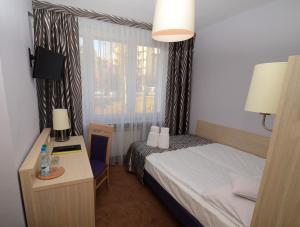 Ένα ή περισσότερα κρεβάτια σε δωμάτιο στο Hotel PZMot
