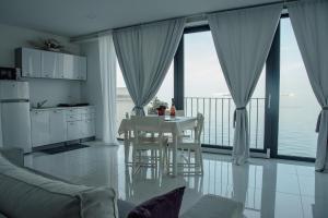 a kitchen and dining room with a view of the ocean at VILA MOLET KOPER in Koper