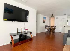 a living room with a large flat screen tv on a wall at House vacation near downtown Dallas in Dallas