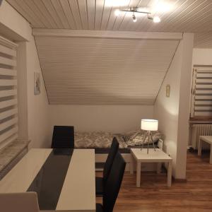 a living room with a bed and a table at Ferienunterkunft Sson in Detmold +8 photos