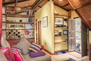 a living room with a couch and some shelves at Shivapuri Heights Cottage in Kathmandu