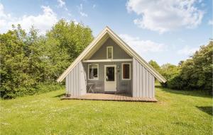 a small house on a grassy field with trees at 2 Bedroom Pet Friendly Home In Sams in Nordby