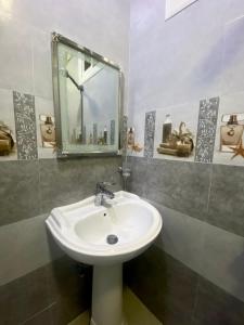 a bathroom with a sink and a mirror at اعمار الشرفه للشقق المفروشه in Najran