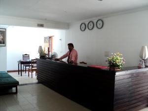 a man standing at a counter in a kitchen at Sea Lotus Park in Trincomalee +58 photos