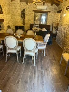 a dining room with a wooden table and chairs at giagias family farm in Kranidi