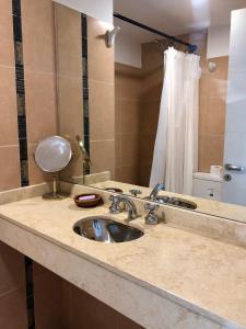 um balcão de casa de banho com um lavatório e um espelho em Güemes Premium, 2 dorm con Vista a las Sierras ALOHA #2 em Córdoba