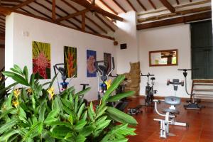 a gym with exercise equipment on the walls at Hotel Mision Santa Barbara in Barichara