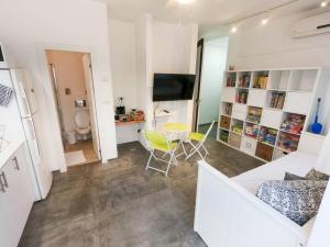 a living room with a couch and a table at Charming unit in Dead Sea in Ovnat